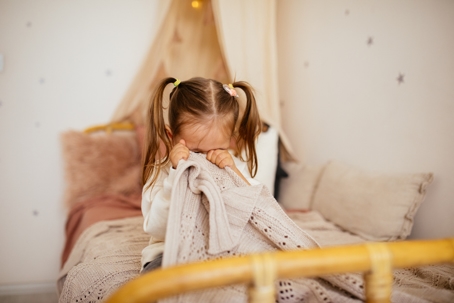 child crying in bed