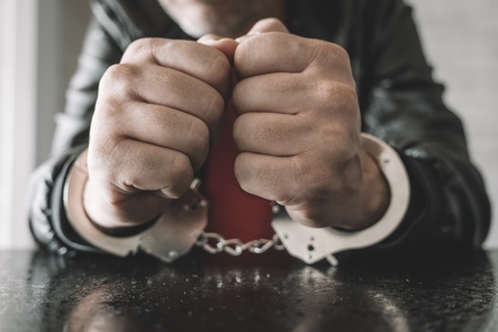 person in handcuffs