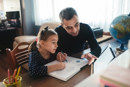 father helping daughter with homework