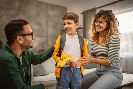 parents helping son get ready for school
