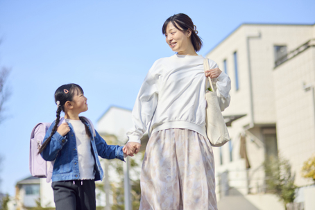 mother and daughter walking to school